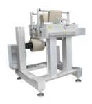 Cut to length station with heavy duty unwind cuts nonwoven material in roll form to size